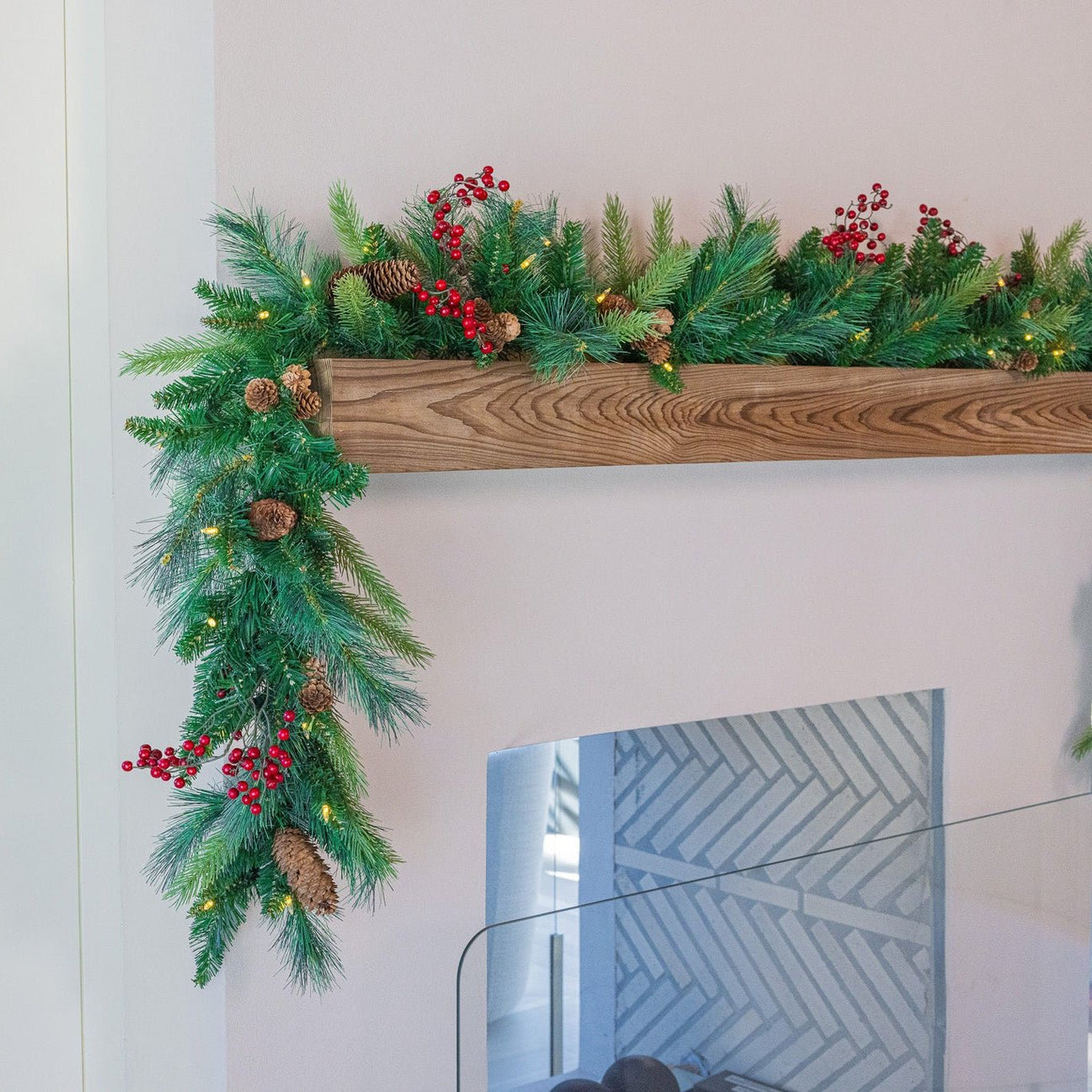 Artificial Christmas garland glowing on mantel