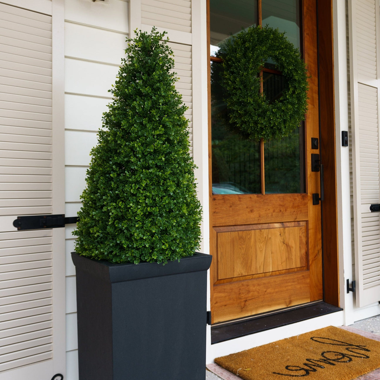 Artificial boxwood spheres styled outdoors for year-round curb appeal