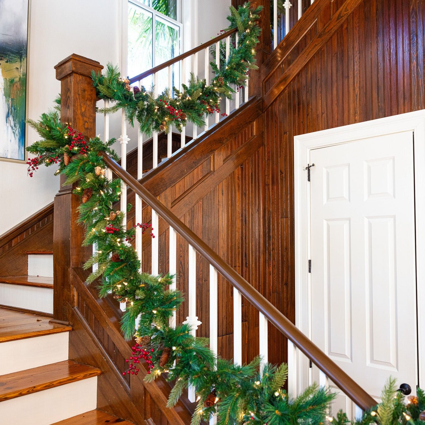 Plug-in Christmas garland on staircase railing